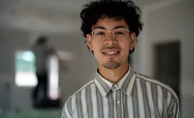 Home owner Oswaldo Herrera poses for a photo in his new home in Langston Park, April 13, 2026, in Atlanta. (AP Photo/Mike Stewart)