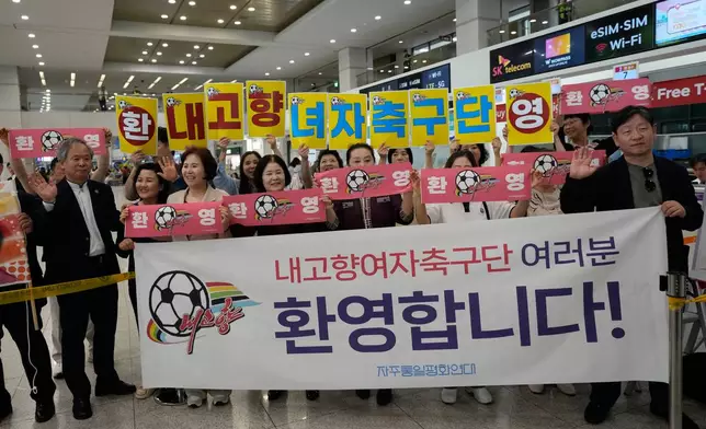 South Korean activists wait for arrival of North Korean soccer club Naegohyang Women's FC team at Incheon International Airport in Incheon, South Korea, Sunday, May 17, 2026. The letters read "Welcome North Korean soccer club Naegohyang Women soccer team." (AP Photo/Ahn Young-joon)