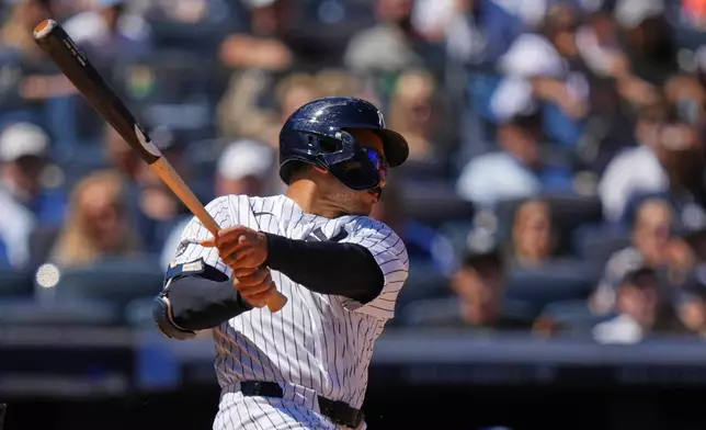 New York Yankees' Trent Grisham follows through on a three-run double during the sixth inning of a baseball game against the Texas Rangers Thursday, May 7, 2026, in New York. (AP Photo/Frank Franklin II)