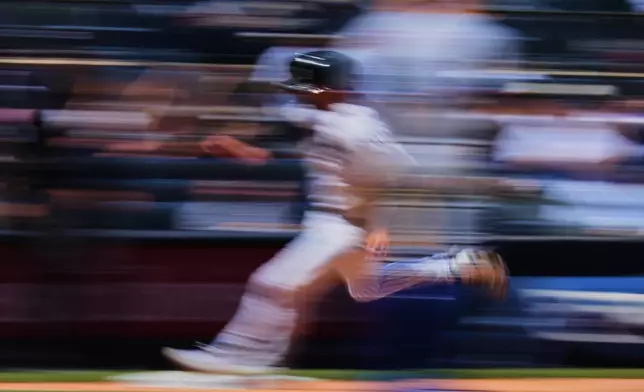 New York Yankees' Ryan McMahon runs to home plate to score on a double by Trent Grisham during the sixth inning of a baseball game Thursday, May 7, 2026, in New York. (AP Photo/Frank Franklin II)