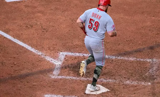 Cincinnati Reds' Blake Dunn scores a run during the fifth inning of a baseball game against the Cleveland Guardians, Saturday, May 16, 2026, in Cleveland. (AP Photo/David Dermer)