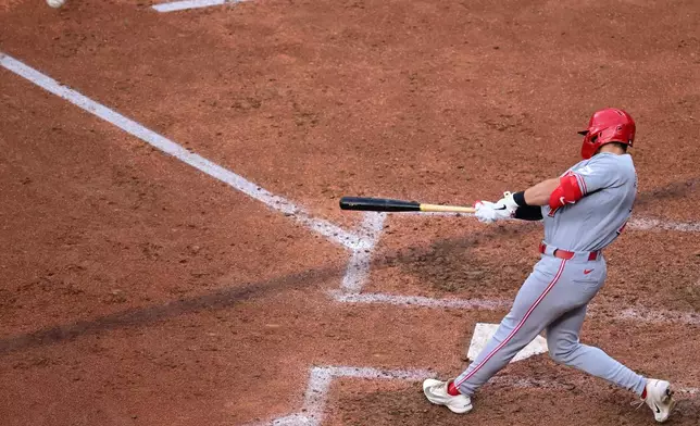 Cincinnati Reds' Spencer Steer hits an RBI double during the fifth inning of a baseball game against the Cleveland Guardians, Saturday, May 16, 2026, in Cleveland. (AP Photo/David Dermer)