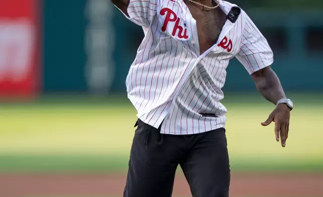 Singer Jason Derulo throws out a ceremonial first pitch prior to a baseball game between the Cincinnati Reds and the Philadelphia Phillies, Tuesday, May 19, 2026, in Philadelphia. (AP Photo/Chris Szagola)