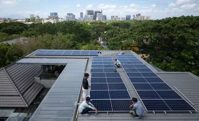 A team of solar installers set up a new rooftop solar system at a home in Manila, Philippines, on May 1, 2026. (AP Photo/Anton L. Delgado)