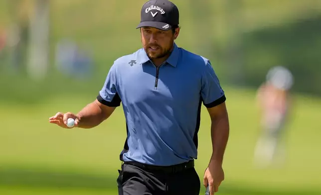 Xander Schauffele waves after his shot on the first green during the final round of the PGA Championship golf tournament at Aronimink Golf Club, Sunday, May 17, 2026, in Newtown Square, PA. (AP Photo/Matt Slocum)
