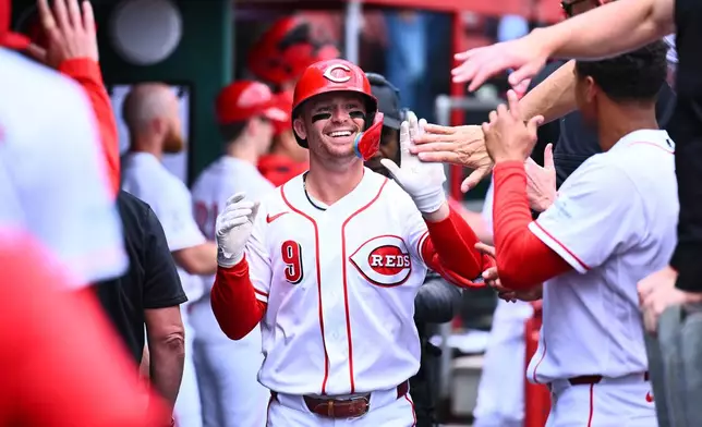 Cincinnati Reds' Matt McLain (9) celebrates his two-run home run with his teammates during the second inning of a baseball game against the Washington Nationals in Cincinnati, Thursday, May 14, 2026. (AP Photo/Ben Jackson)