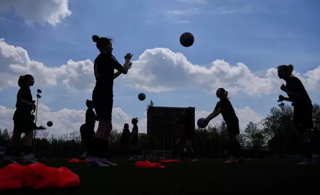 AKS Zly Praga players exercise during warmup before Women's II Liga Kobiet North soccer match between AKS Zly Praga and KKP Slupczanka Slupca, at the Don Pedro Arena stadium in Warsaw, Poland, Saturday, April 25, 2026. (AP Photo/Ebrahim Noroozi)