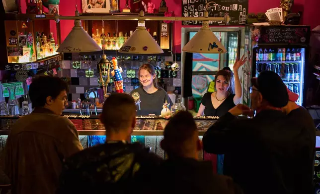 AKS Zly Praga soccer team fans gather at the Offside bar, in Praga district in Warsaw, Poland, Friday, April 24, 2026. (AP Photo/Ebrahim Noroozi)