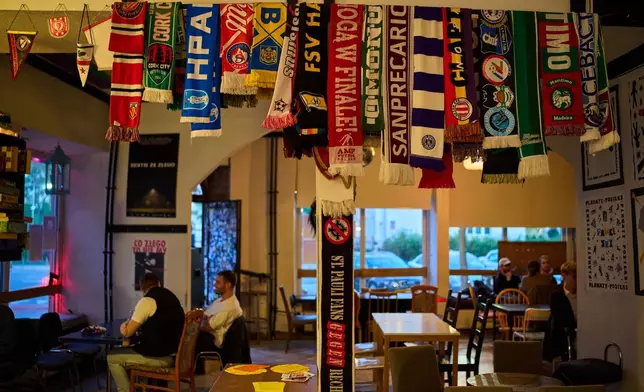 Anti-fascist team scarves are collected at the Offside bar, while AKS Zly Praga soccer team fans gather at the Offside bar, in Praga district in Warsaw, Poland, Friday, April 24, 2026. (AP Photo/Ebrahim Noroozi)