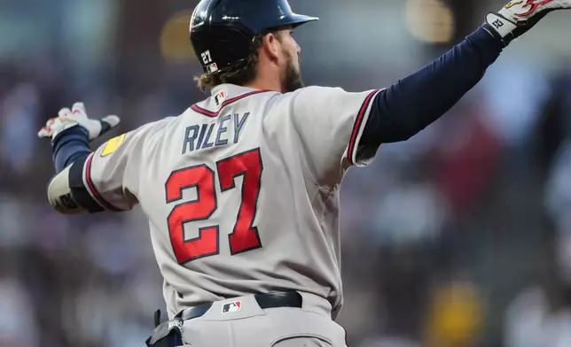 Atlanta Braves' Austin Riley gestures to the bullpen as he circles the bases after hitting a two-run home run off Colorado Rockies relief pitcher Chase Dollander in the fifth inning of a baseball game Saturday, May 2, 2026, in Denver. (AP Photo/David Zalubowski)