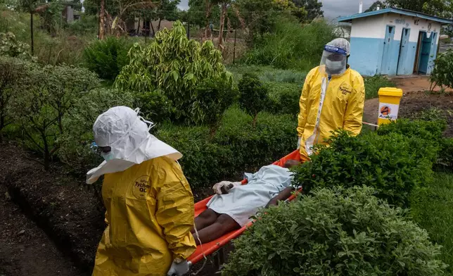 Medical staff carry an Ebola patient to a treatment center in Rwampara, Congo, Thursday, May 21, 2026. (AP Photo/Moses Sawasawa)