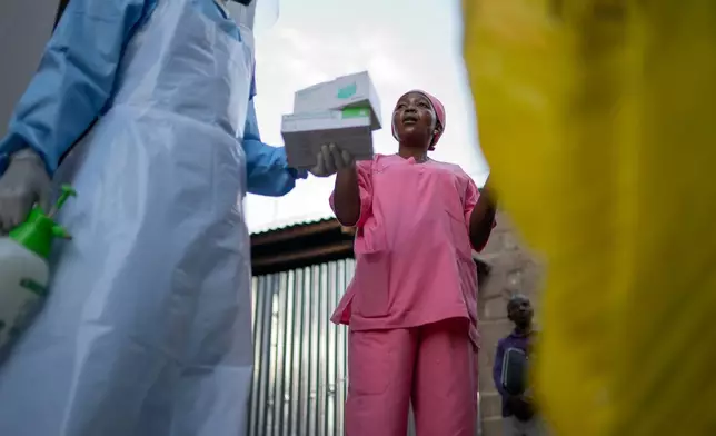 Manza Pantience, a midwife at Karibuni wa Mama, supervises health workers who collect patients' samples for Ebola testing at Sofepadi Hospital in Bunia, Congo, Friday, May 29, 2026. (AP Photo/Moses Sawasawa)