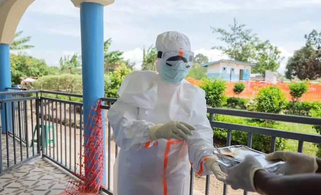 A health worker collects meals for Ebola patients at the treatment center in Rwampara, Congo, Friday, May 29, 2026. (AP Photo/Moses Sawasawa)