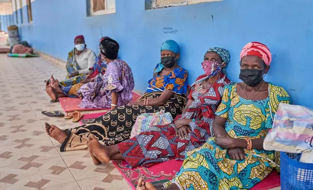 People in protective masks wait in the corridor of a hospital in Bunia, Congo, Tuesday, May 19, 2026. (AP Photo/Dirole Lotsima Dieudonne)
