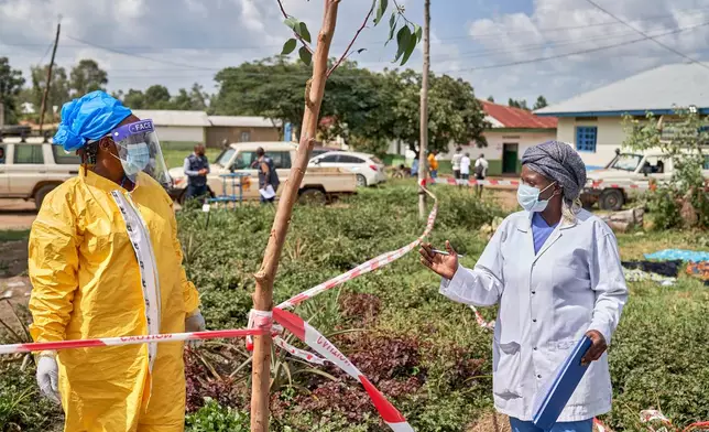 Health workers chat at an Ebola treatment center in Bunia, Congo, Tuesday, May 19, 2026. (AP Photo/Dirole Lotsima Dieudonne)