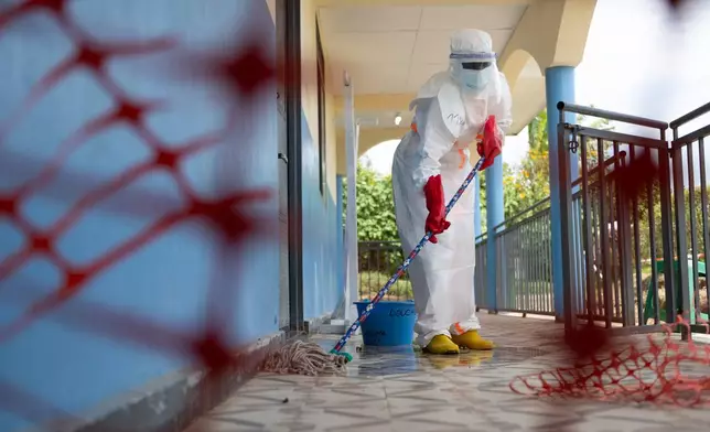 A health worker mops the floor at the Ebola treatment center in Rwampara, Congo, Friday, May 29, 2026. (AP Photo/Moses Sawasawa)