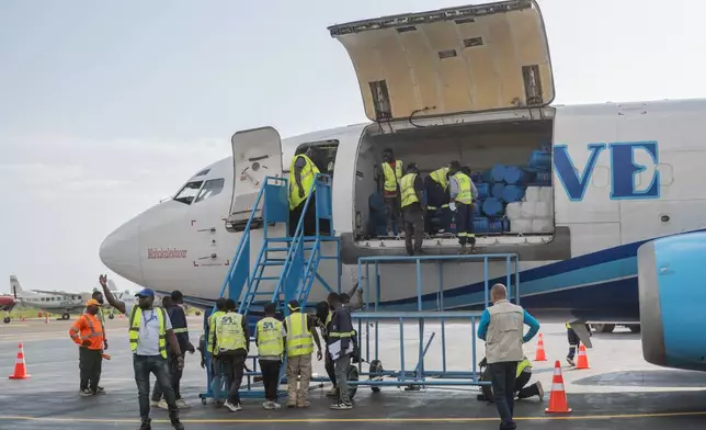 People offload a shipment of more than 15 tonnes of supplies donated by UNICEF as part of the response to the Ebola virus outbreak at Bunia National Airport in Bunia, Congo, Tuesday, May 19, 2026. (AP Photo/Moses Sawasawa)