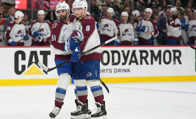 Colorado Avalanche center Nazem Kadri (91) celebrates with defenseman Cale Makar (8) after scoring a goal during the second period of Game 4 in an NHL Stanley Cup hockey second-round playoff series against the Minnesota Wild Monday, May 11, 2026, in St. Paul, Minn. (AP Photo/Abbie Parr)