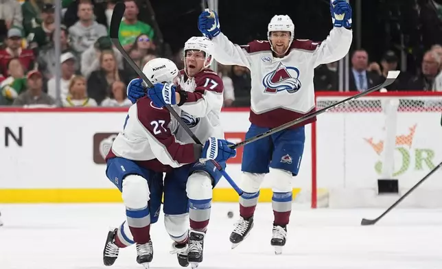 Colorado Avalanche center Parker Kelly, center, celebrates after scoring during the third period of Game 4 in an NHL Stanley Cup hockey second-round playoff series against the Minnesota Wild, Monday, May 11, 2026, in St. Paul, Minn. (AP Photo/Abbie Parr)