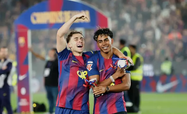 Barcelona's Gavi and Lamine Yamal celebrate after winning the Spanish La Liga soccer match against Real Madrid to clinch the Spanish league title in Barcelona, Spain, Sunday, May 10, 2026. (AP Photo/Joan Monfort)