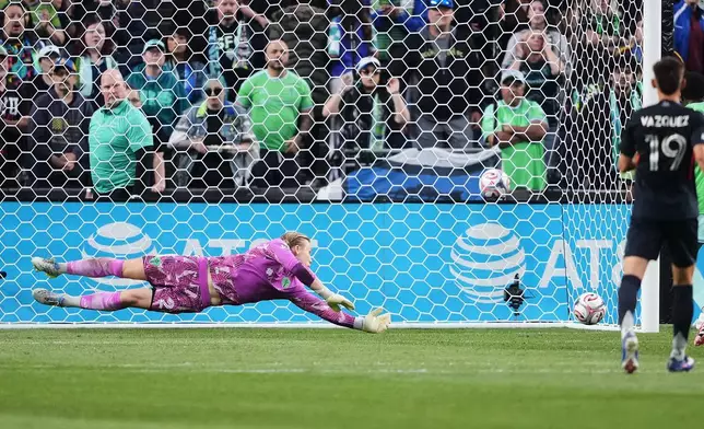 Seattle Sounders goalkeeper Andrew Thomas dives to keep a San Diego FC shot out of the goal during the first half of an MLS soccer match, Saturday, May 9, 2026, in Seattle. (AP Photo/Lindsey Wasson)