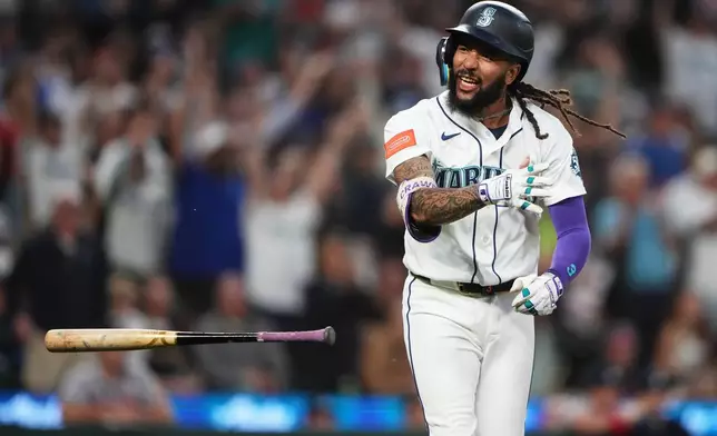 Seattle Mariners' J.P. Crawford celebrates after hitting a two-run home run against the Atlanta Braves during the sixth inning of a baseball game, Monday, May 4, 2026, in Seattle. (AP Photo/Lindsey Wasson)