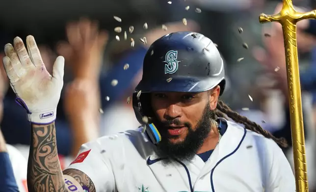 Seattle Mariners' J.P. Crawford celebrates in the dugout after hitting a two-run home run against the Atlanta Braves during the sixth inning of a baseball game, Monday, May 4, 2026, in Seattle. (AP Photo/Lindsey Wasson)