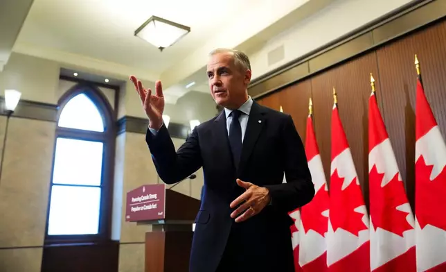 Prime Minister Mark Carney leaves after making an announcement on Parliament Hill in Ottawa on Thursday, May 14, 2026. (Sean Kilpatrick/The Canadian Press via AP)