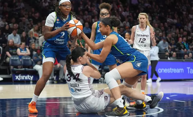 Minnesota Lynx forward Liatu King (2) gains possession of the ball from Toronto Tempo center Mariella Fasoula (34) during the second half of a WNBA basketball game Thursday, May 21, 2026, in Minneapolis. (AP Photo/Abbie Parr)