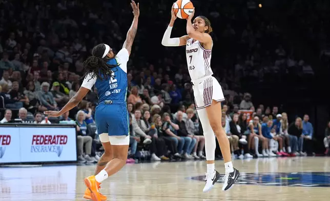 Toronto Tempo forward Teonni Key (7) shoots over Minnesota Lynx forward Liatu King (2) during the second half of a WNBA basketball game Thursday, May 21, 2026, in Minneapolis. (AP Photo/Abbie Parr)