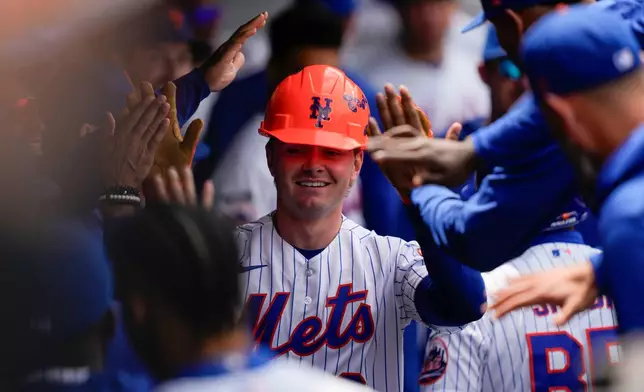 New York Mets' A.J. Ewing (9) celebrates in the dugout with teammates after hitting a home run during the third inning of a baseball game against the Detroit Tigers, Thursday, May 14, 2026, in New York. (AP Photo/Yuki Iwamura)