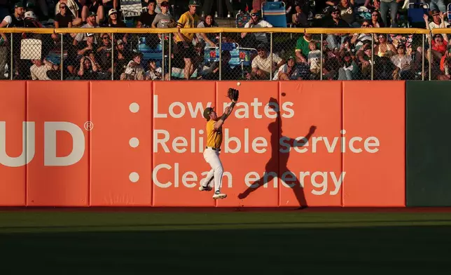 Athletics center fielder Henry Bolte attempts to catch a fly ball hit by San Francisco Giants' Drew Gilbert during the fourth inning of a baseball game Saturday, May 16, 2026, in West Sacramento, Calif. (AP Photo/Sara Nevis)