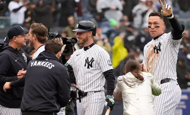 New York Yankees' Aaron Judge, right, reacts after hitting a two-run walk-off home run during the ninth inning of a baseball game against the Tampa Bay Rays, Sunday, May 24, 2026, in New York. (AP Photo/Seth Wenig)