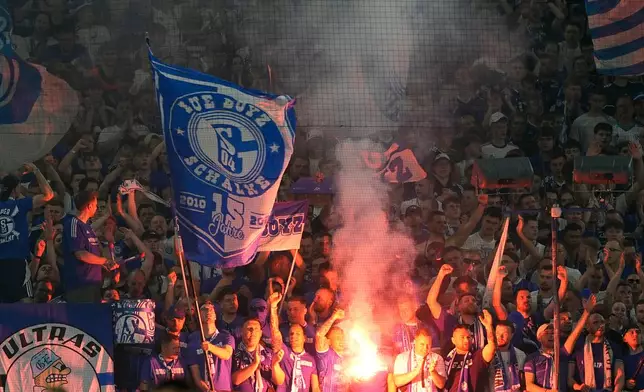 Schalke fans light flares during the German Bundesliga 2 soccer match between FC Schalke 04 and Fortuna Duesseldorf in Gelsenkirchen, Germany, Saturday, May 2, 2026. (AP Photo/Martin Meissner)