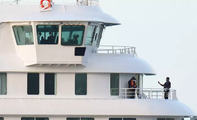 Passengers and crew at the hantavirus-stricken cruise ship MV Hondius after arriving at the port of Granadilla in Tenerife, Canary Islands, Spain, Sunday, May 10, 2026. (AP Photo/Manu Fernandez)