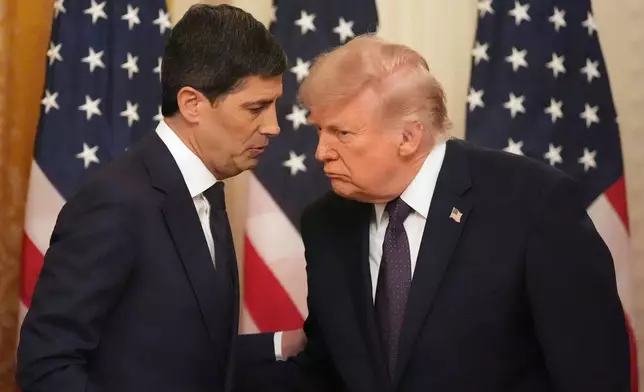 President Donald Trump, right, speaks with Federal Reserve Chairman Kevin Warsh during Warsh's swearing-in in the East Room of the White House, Friday, May 22, 2026, in Washington. (AP Photo/Alex Brandon)