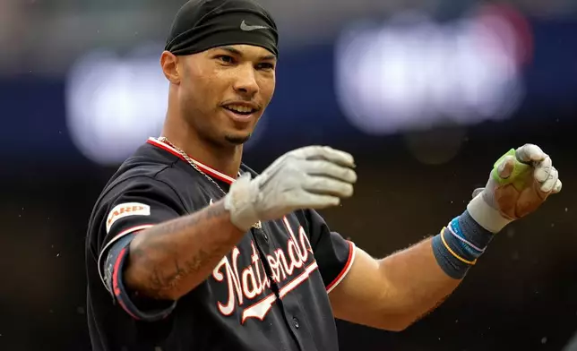 Washington Nationals' Daylen Lile reacts to sliding safe to third base after hitting a triple in the second inning of a baseball game against the Atlanta Braves, Saturday, May 23, 2026, in Atlanta. (AP Photo/Mike Stewart)