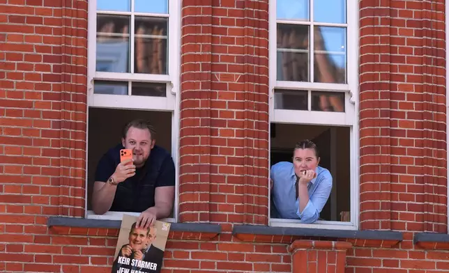 People look out of a window near the scene where two people were stabbed the previous day in the Golders Green neighbourhood, which has a large Jewish community, in London, Thursday, April 30, 2026. (AP Photo/Alastair Grant)