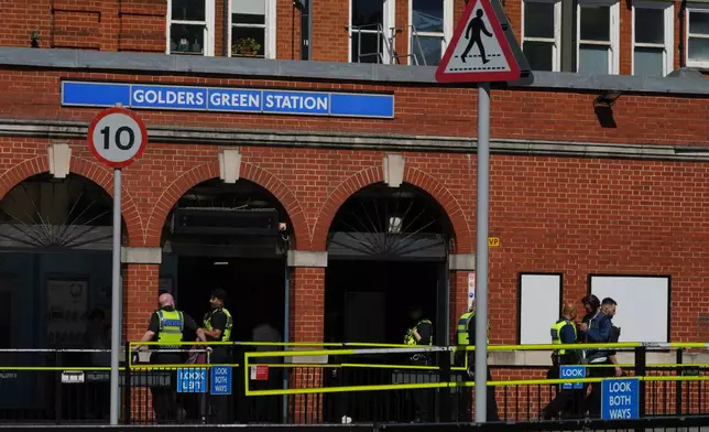 Police on duty outside Golders Green tube station in London, Thursday, April 30, 2026, near the scene where two people were recently stabbed in the Golders Green neighbourhood, that has a large Jewish community. (AP Photo/Alastair Grant)