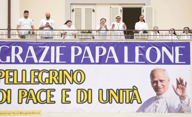 People show a banner reading " Thank you, Pope Leo, pilgrim of peace and unity" during Pope Leo XIV's visit in Pompeii, Italy, Friday, May 8, 2026. (AP Photo/Gregorio Borgia)