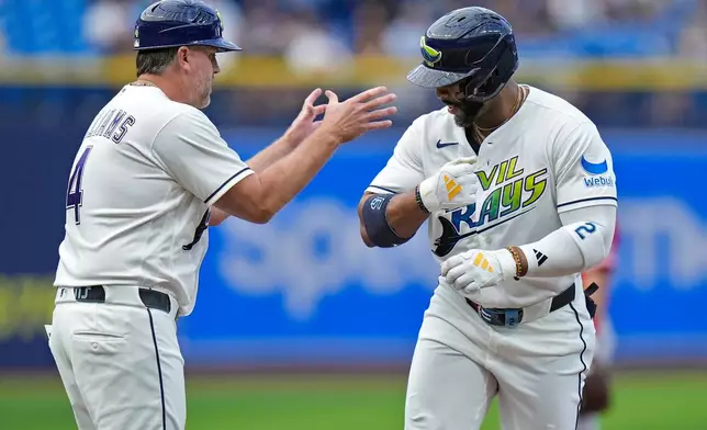 Tampa Bay Rays' Yandy Díaz celebrates his home run off Los Angeles Angels pitcher Walbert Ureña with third base coach Brady Williams (4) during the first inning of a baseball game Friday, May 29, 2026, in St. Petersburg, Fla. (AP Photo/Chris O'Meara)