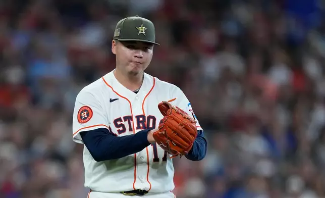 Houston Astros pitcher Kai-Wei Teng claps after getting out of a jam during the fourth inning of a baseball game against the Texas Rangers, Saturday, May 16, 2026, in Houston. (AP Photo/Kevin M. Cox)