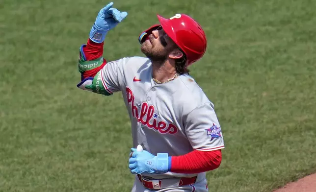 Philadelphia Phillies' Bryce Harper celebrates as he rounds the bases after hitting a solo home run off Pittsburgh Pirates pitcher Paul Skenes during he sixth inning of a baseball game in Pittsburgh, Sunday, May 17, 2026. (AP Photo/Gene J. Puskar)