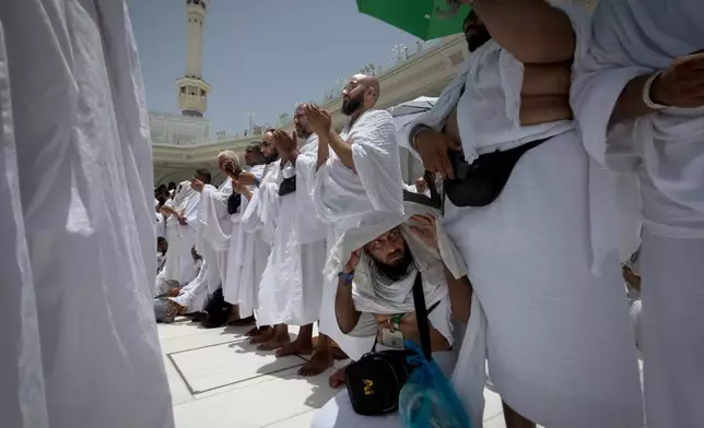 Muslim pilgrims pray in front of the Kaaba, the cubic building at the Grand Mosque, during the annual Hajj pilgrimage in the Muslim holy city of Mecca, Saudi Arabia, Thursday, May 21, 2026. (AP Photo/Altaf Qadri)
