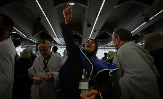 Muslim pilgrims cast pebbles at pillars in the symbolic stoning of the devil, the last rite of the annual Hajj, in Mina near the holy city of Mecca, Saudi Arabia, Wednesday, May 27, 2026. (AP Photo/Altaf Qadri)