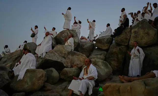 Muslim pilgrims pray at top of the rocky hill known as the Mountain of Mercy, on the Plain of Arafat, during the annual Hajj pilgrimage near the holy city of Mecca, Saudi Arabia, Tuesday, May 26, 2026. (AP Photo/Altaf Qadri)