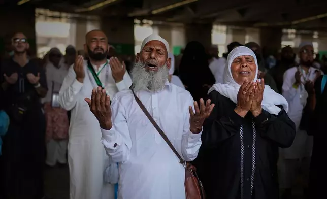Muslim pilgrims pray after casting pebbles at pillars in the symbolic stoning of the devil on the second day of the ritual, one of the final rites of the annual Hajj pilgrimage, in Mina near Mecca, Saudi Arabia, Thursday, May 28, 2026. (AP Photo/Altaf Qadri)