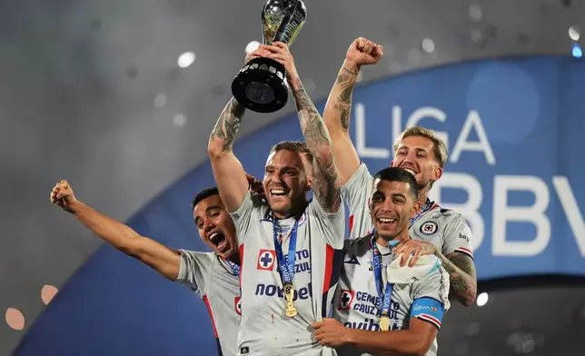 Cruz Azul's players celebrate with the trophy after winning the Mexican soccer league final against Pumas in Mexico City, Sunday, May 24, 2026. (AP Photo/Fernando Llano)
