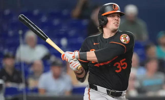 Baltimore Orioles' Adley Rutschman watches his ball after hitting a double to bring home Taylor Ward, during the fifth inning of a baseball game against the Miami Marlins, Wednesday, May 6, 2026, in Miami. (AP Photo/Rebecca Blackwell)