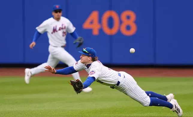 New York Mets' Carson Benge (3) dives for a ball hit by Washington Nationals' Nasim Nuñez for a single during the ninth inning of a baseball game Thursday, April 30, 2026, in New York. (AP Photo/Frank Franklin II)